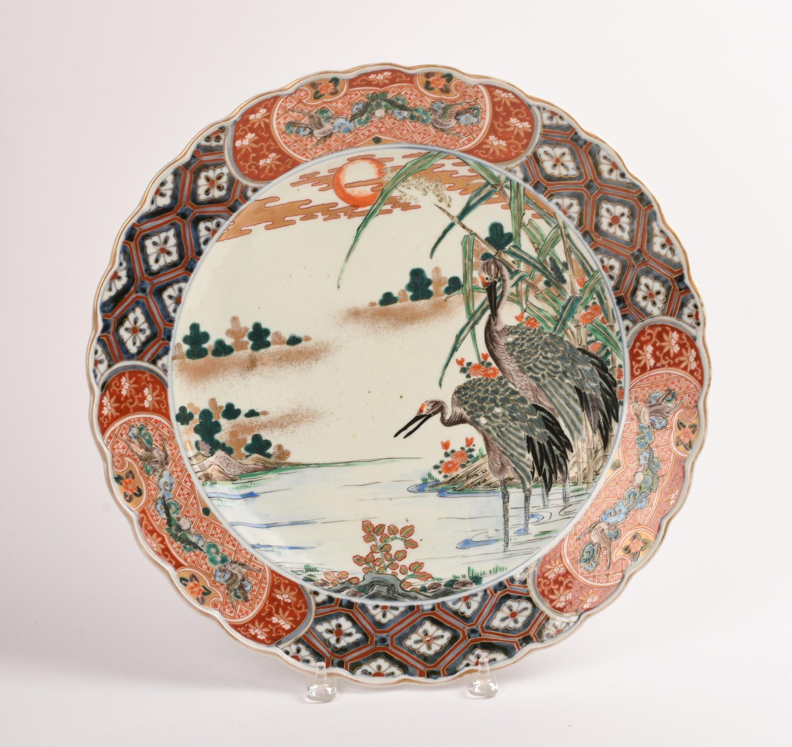 Japanese Imari Porcelain Charger: Decorated with two cranes wading in a lake under moonlight, 19th century, diameter 16.25 inches, good condition
