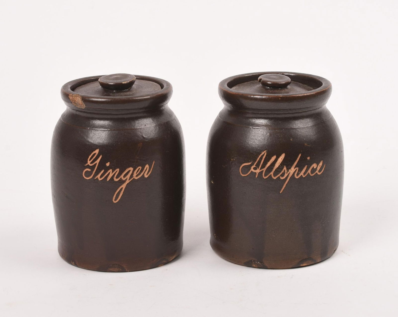 Pair of Redware Spice Jars.: Allspice and Ginger, height 4 inches. Chip to rim of giner.