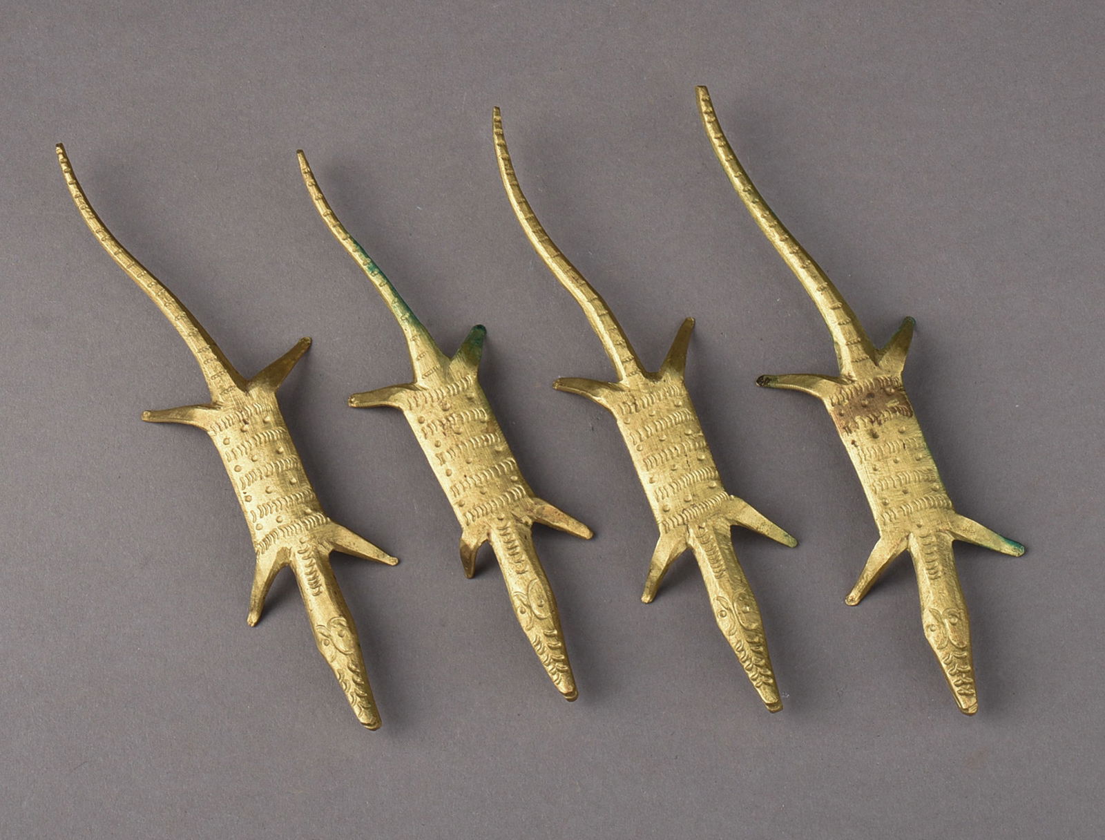 FOUR AFRICAN BRASS ALLIGATORS: Length of longest 5.25 inches.
