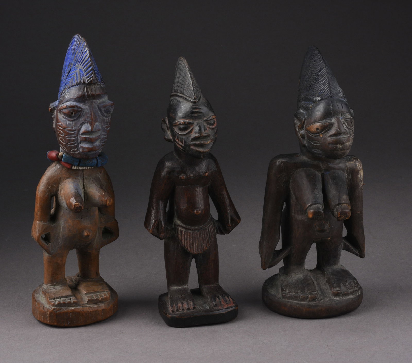 THREE YORUBA IBEJI DOLLS: Height of tallest 9 inches.