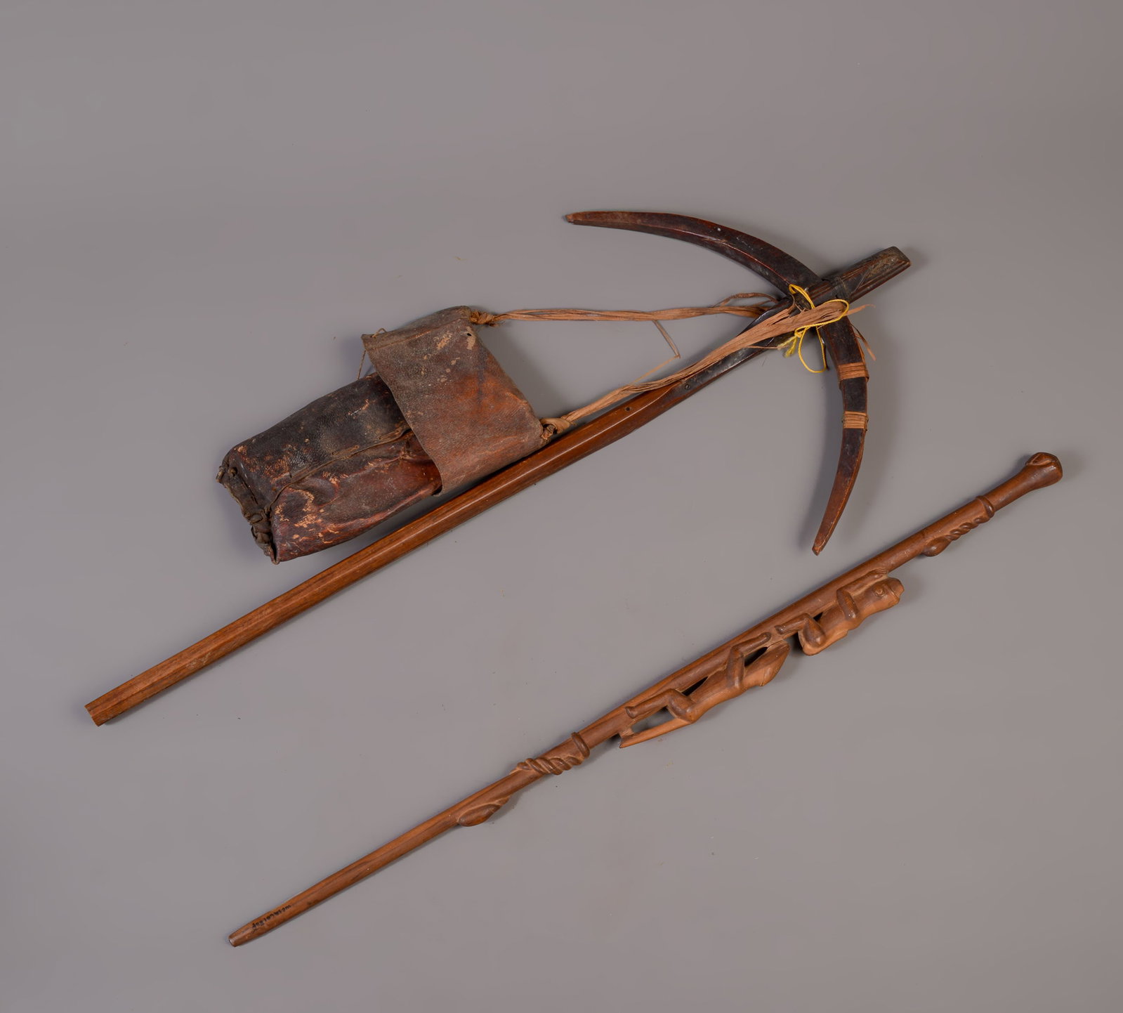 CROSSBOW AND A FIGURAL CANE: Length of crossbow 39 inches.