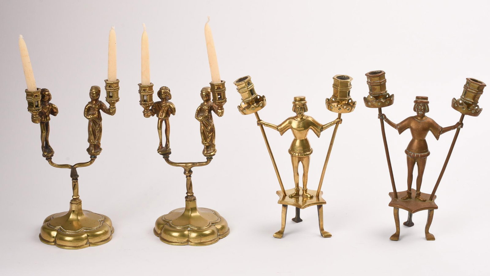 Two Pairs of Brass Two Light Candleholders: With Medieval figures, taller pair height 9.5 inches