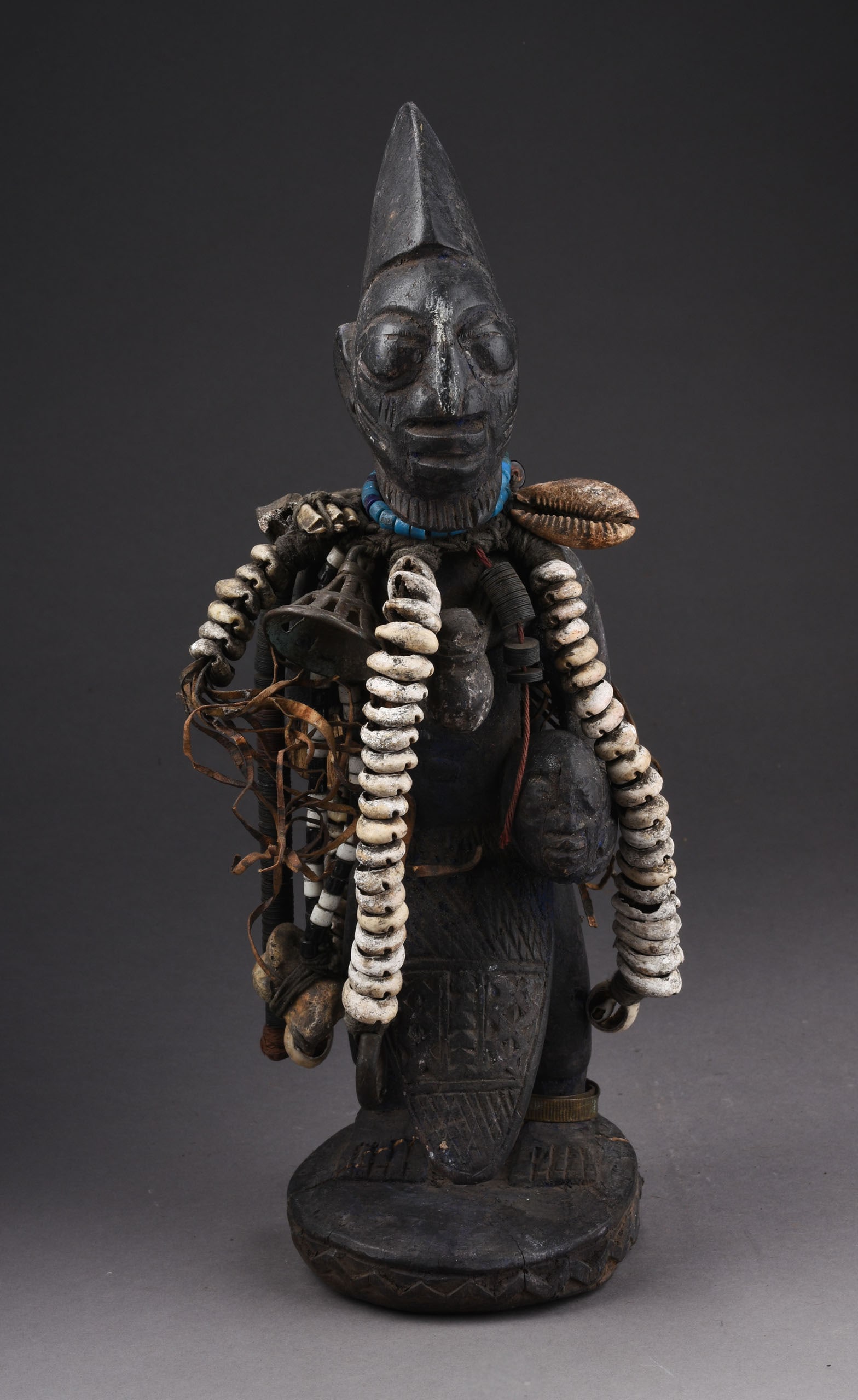 19TH CENTURY, YORUBA CARVED WOODEN ESHU FIGURE: Height 15 inches. Trickster spirit: in the Yoruba religion, Eshu is a trickster god, orisha, Who is the messenger between ifa the chief god, and the humans: Eshu is responsible for both good and bad c