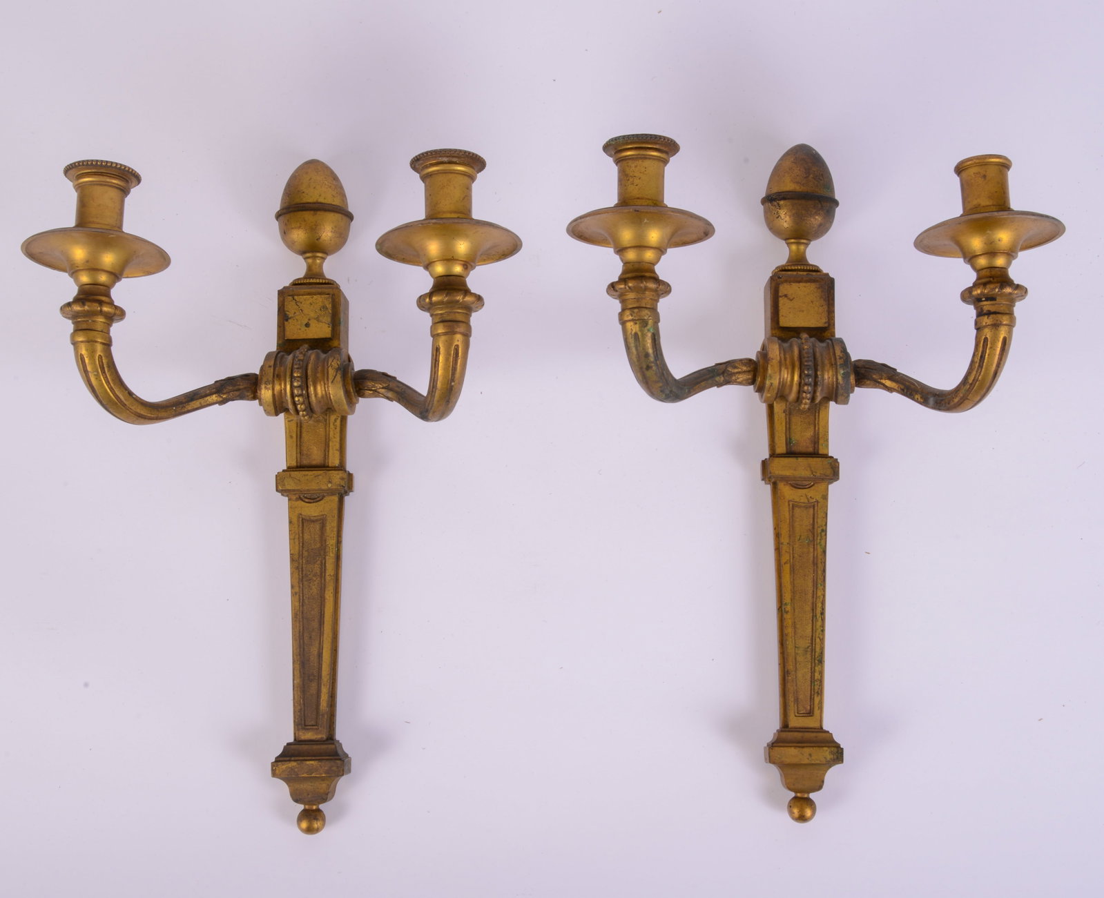 Pair of Gilt Bronze Sconces: Acorn finials, 19th c., missing one bobeche. Height 16.5 inches.