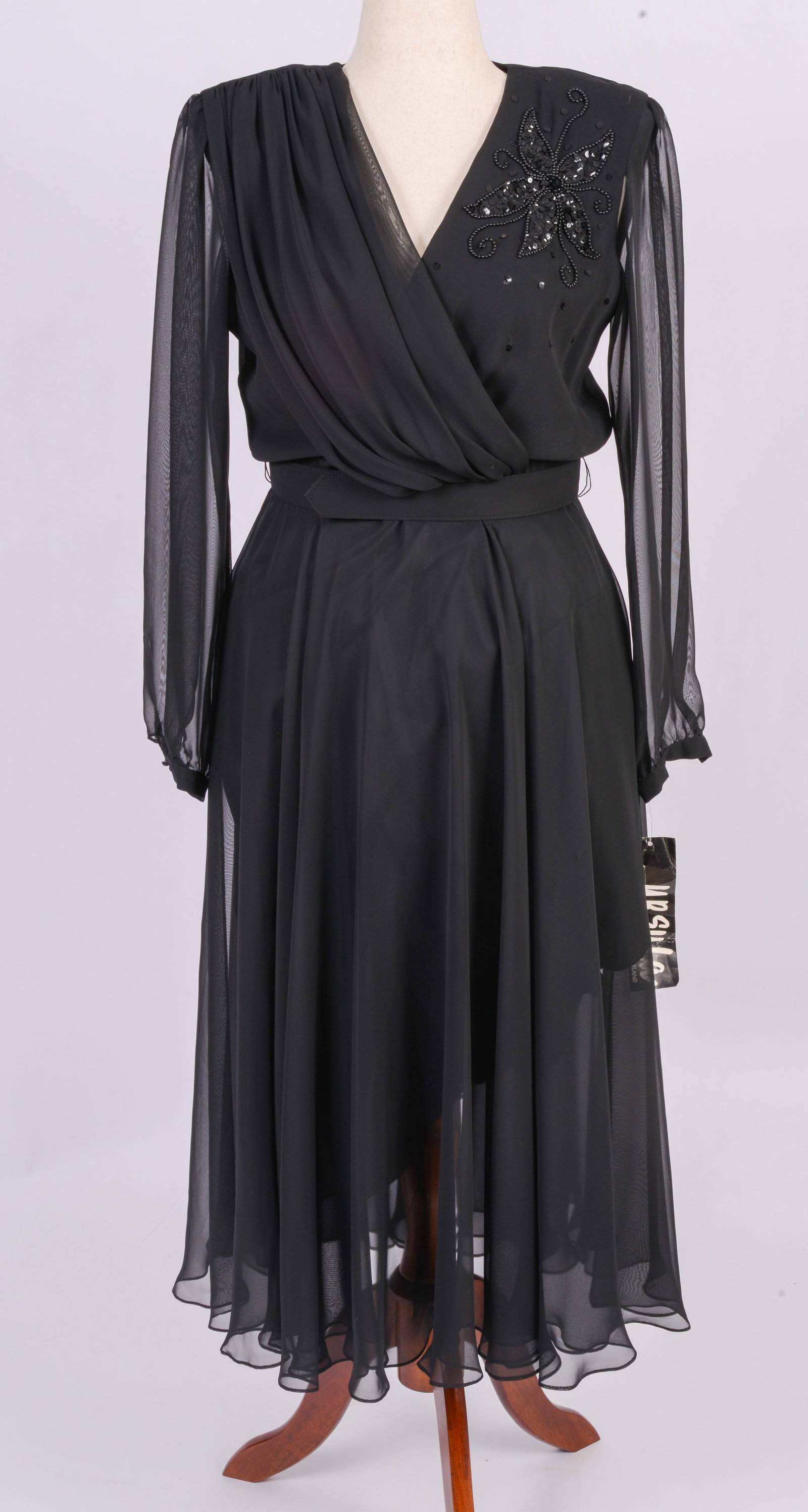 Ursula of Switzerland Black Belted Dress: Sequin and bead flourish on left shoulder. 1980s style. Size 12, length 51 inches, with tag. Good condition.