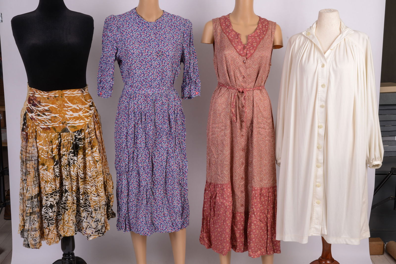 Four Pieces of Women's Clothing: April Cornell small dress, Scarlett Lane medium skirt, Fane Schaffhausen size 12 floral print dress, Jean Varon Mirror Room oversized button down shirt with stains on back of right arm