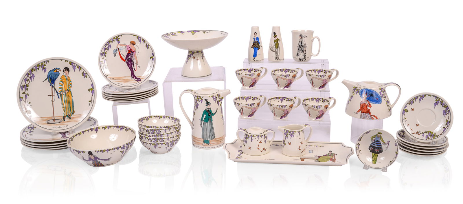 VILLEROY & BOCH DESIGN 1900 TEA AND COFFEE SET: With women in fashionable turn of the century french couture, including teapot, coffee pot, creamer and sugar, salt and pepper, 5 dinner plates diameter 10.25 inches, 6 salad plates, 1 mug, 6 teacups,