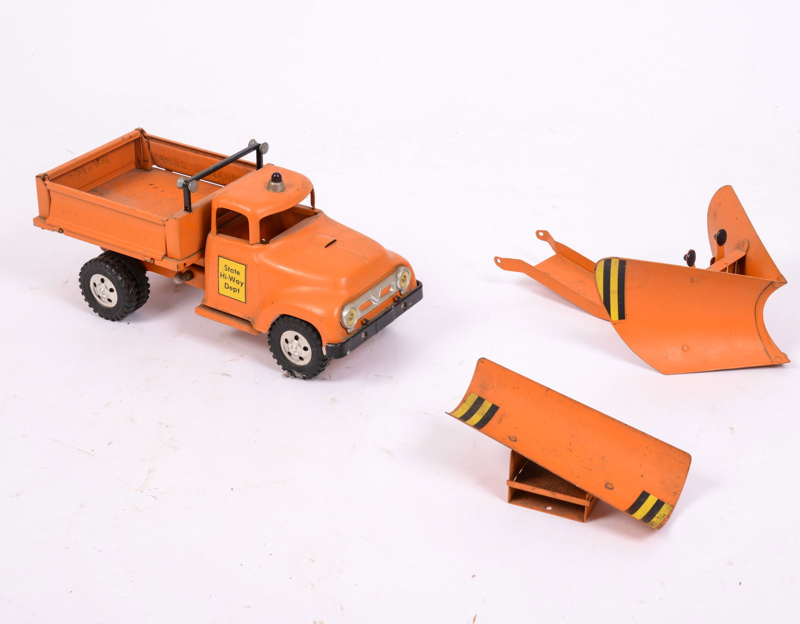 TONKA SNOW PLOW TRUCK WITH PLOW ATTACHMENTS: Height 6 inches, length without plow attachments 13 inches. Orange, State Hi-Way Dept, hydraulic dump truck. Good condition, wear consistent with age.