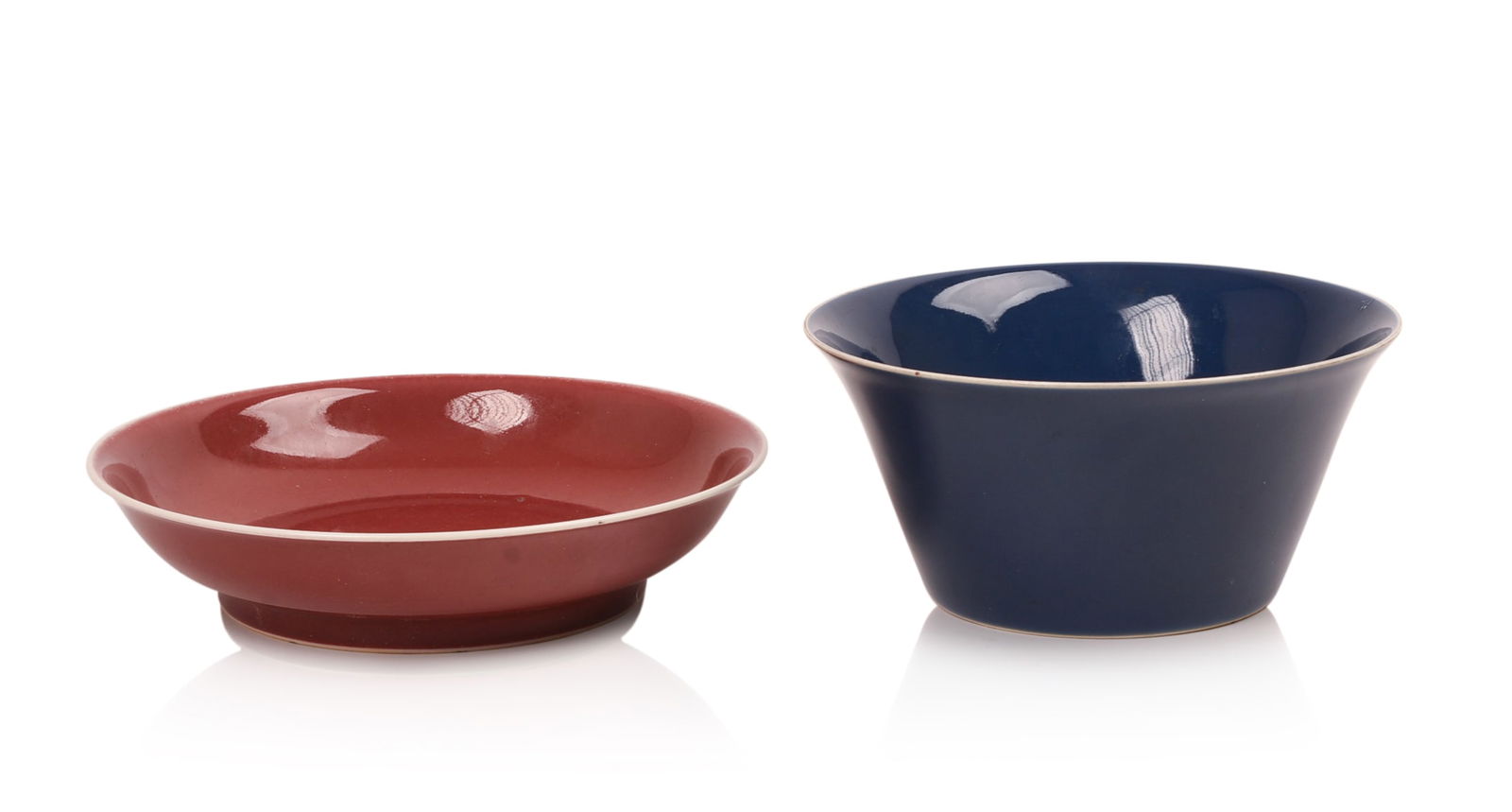 TWO CHINESE PORCELAIN SOLID COLOR DISHES.: A blue bowl, Ching dynasty, diameter 6.25 inches, with label for Vermeer & Griggs Asian Art. An oxblood red bowl, diameter 7 inches, six character mark in underglaze blue. Both in excellent condition.