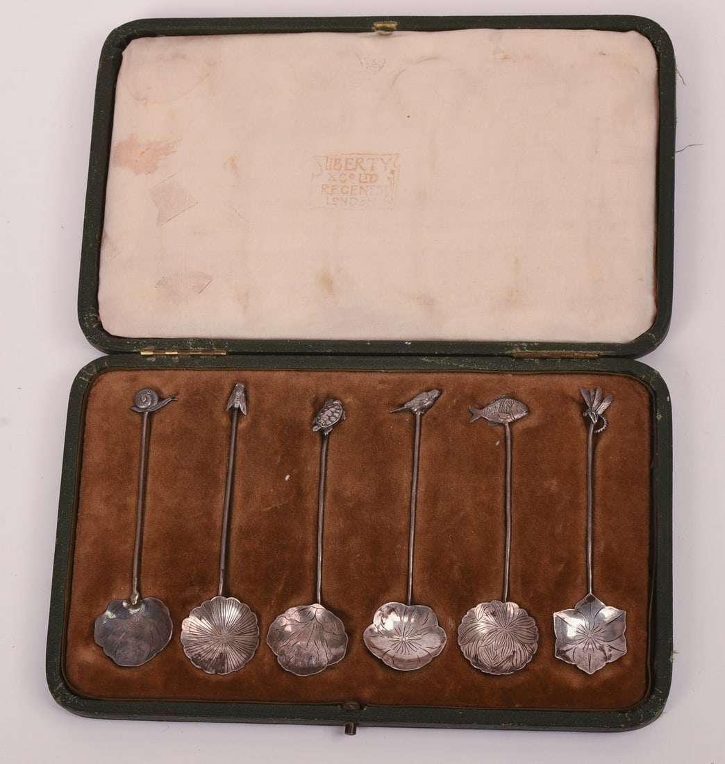 SIX JAPANESE SILVER SPOONS FOR LIBERTY CO.: Each topped with a different animal, including: a turtle, dragon fly, snail, bird, fish and a fly. Hallmarked WS and each with Liberty and Co. marks and English hallmarks, original Liberty box. Total 