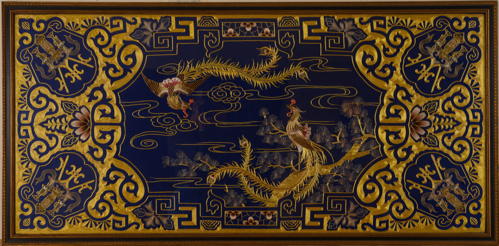 CHINESE GOLDWORK EMBROIDERY PHOENIX SILK PANEL: 27.75 x 58 inches, sight. Framed, 31 x 62 inches. A few loose threads, some minor abrasions to frame.