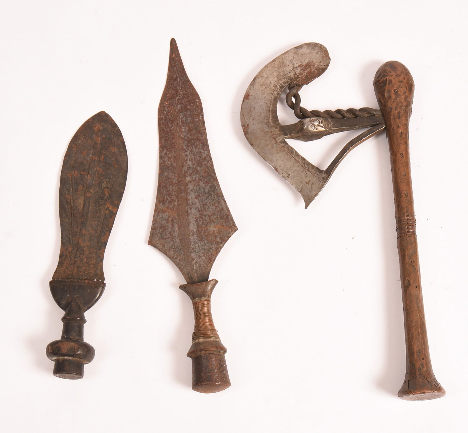 THREE AFRICAN WEAPONS.: Including an axe, length 17 inches, and two daggers. Some wear.