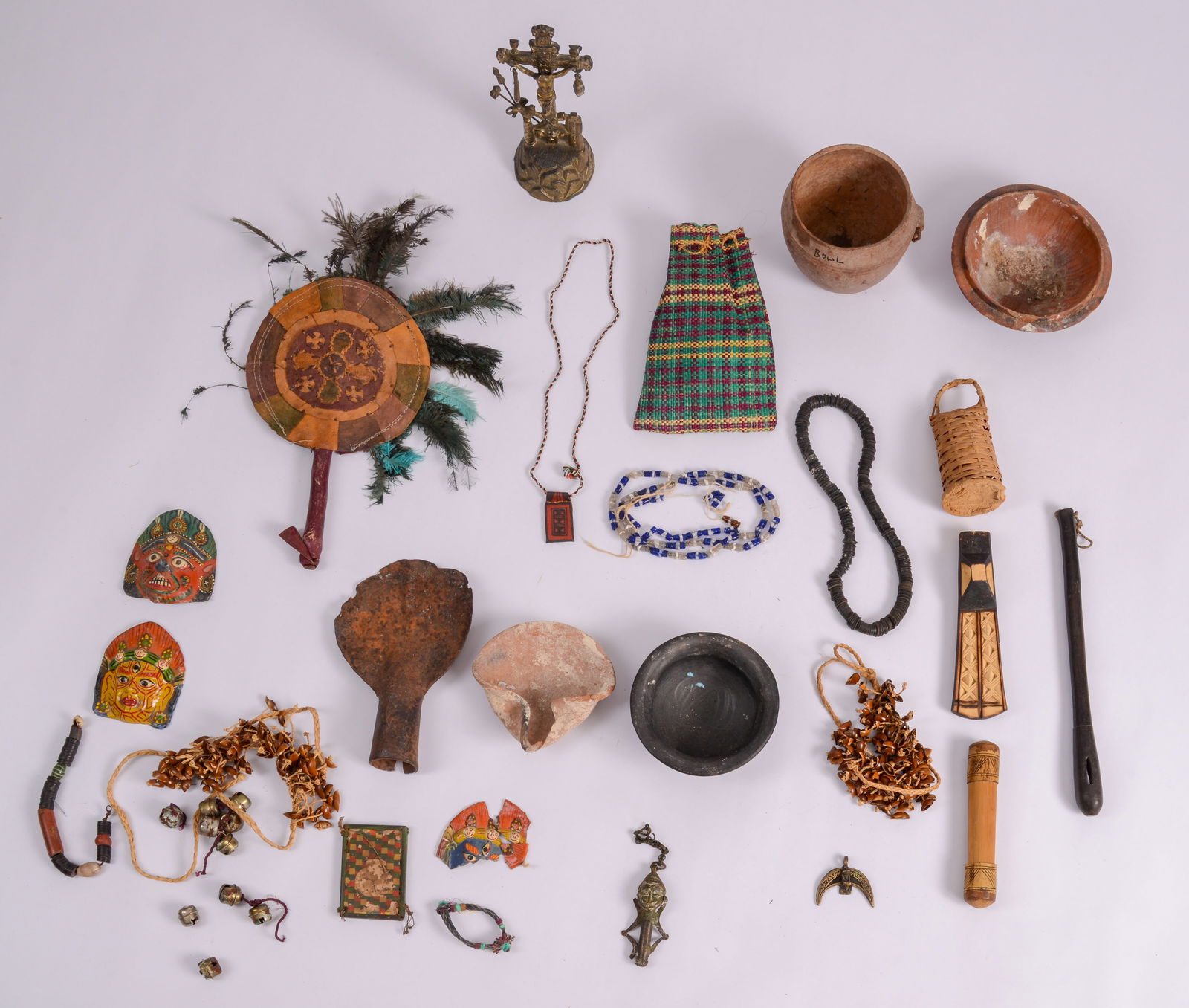 COLLECTION OF AFRICAN DECORATIVE OBJECTS.: Including clay bowls, necklaces, and others. Also includes a brass crucifix.