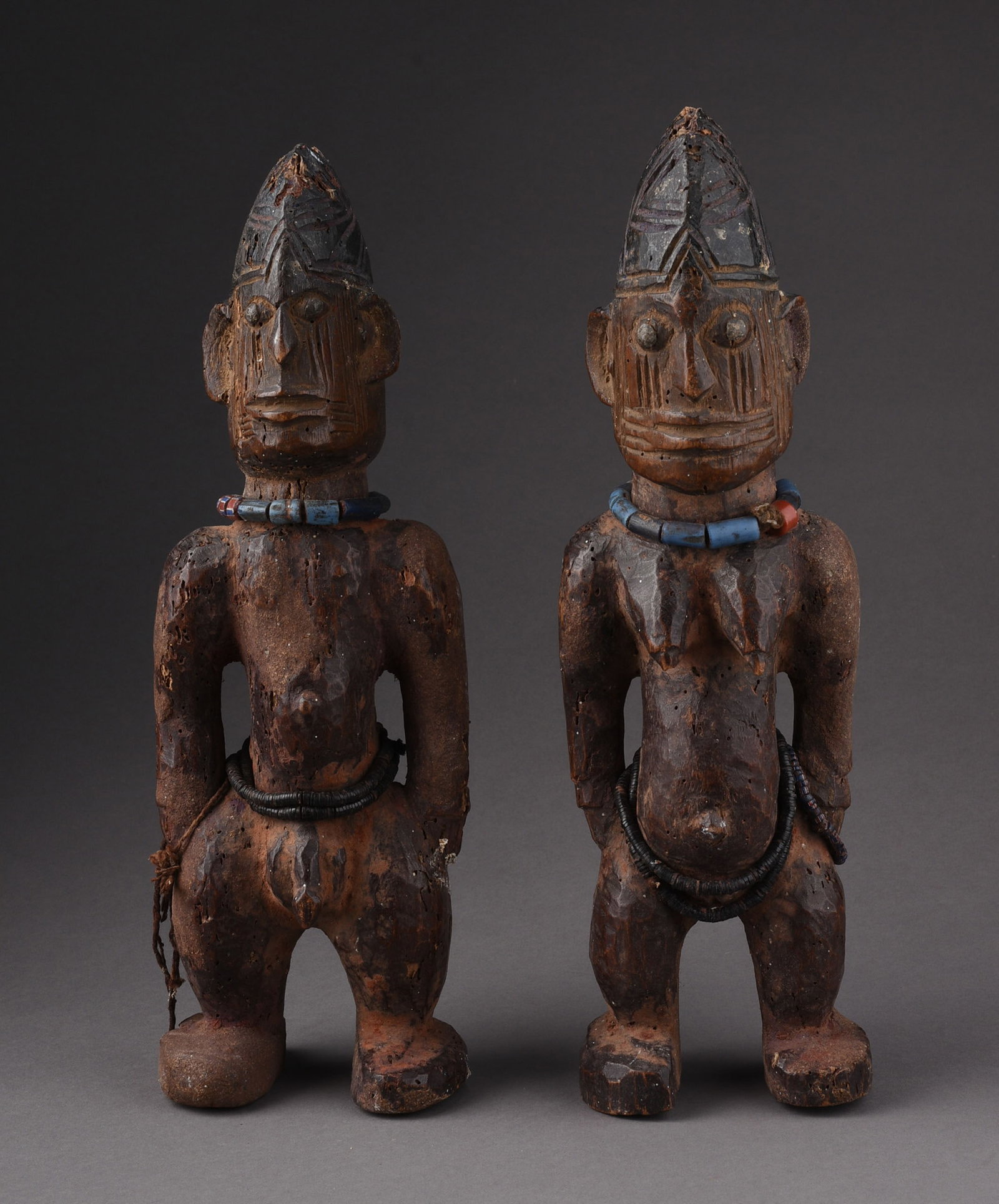 PAIR OF YORUBA IBEJI FIGURES NIGERIA, WOOD, BEADS AND ENCRUSTATION: Height 12.5 inches. Age related wear and losses.