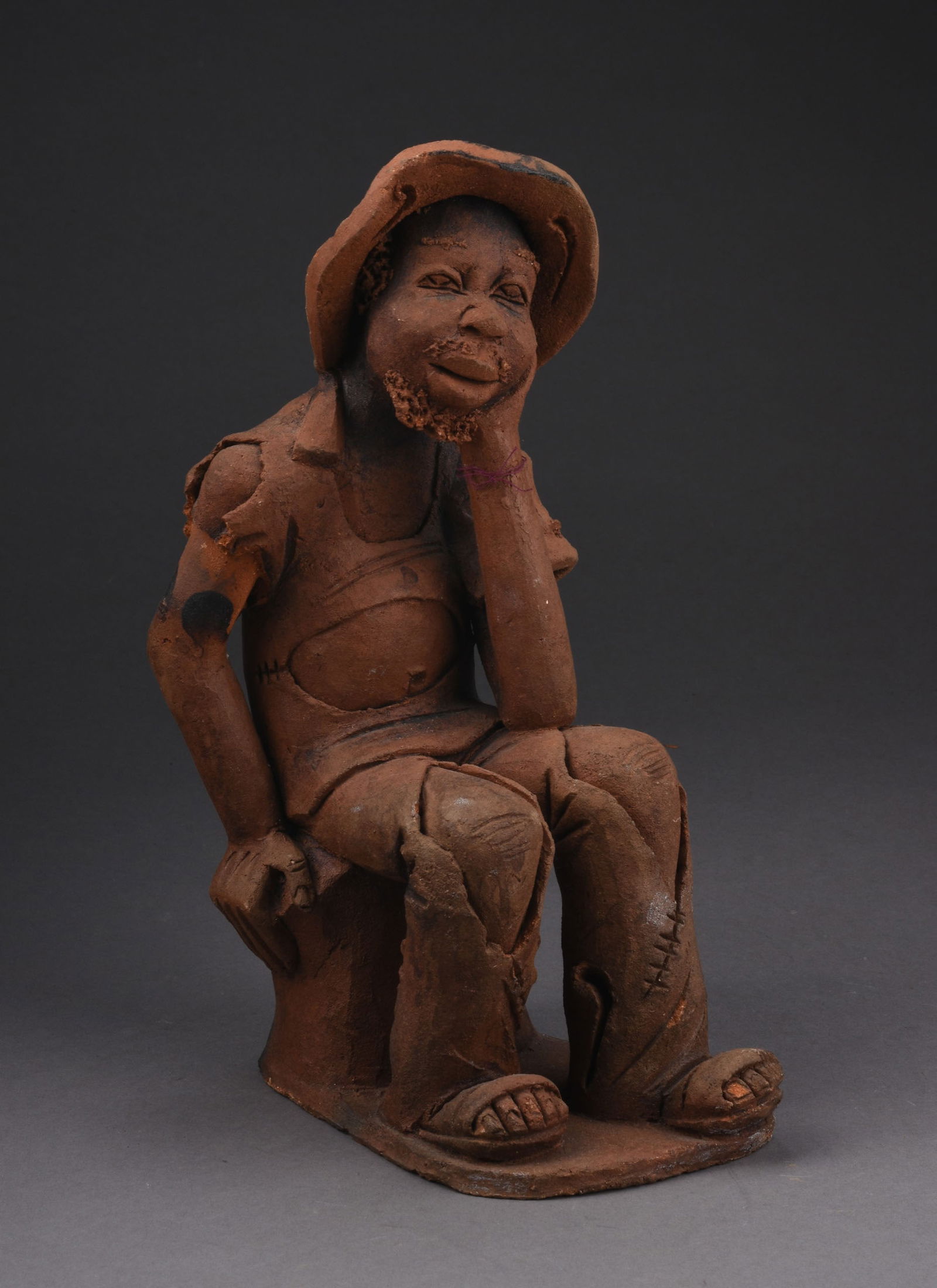 ANGOLAN CLAY SCULPTURE OF A MAN (1 of 5)