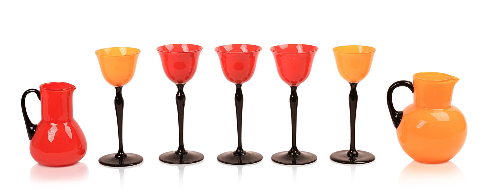 SEVEN PIECES FLAVIO POLI MURANO GLASS.: Including two pitchers, heights 4.5 and 6 inches, and five stem glasses, height 7 inches. All in very good condition.