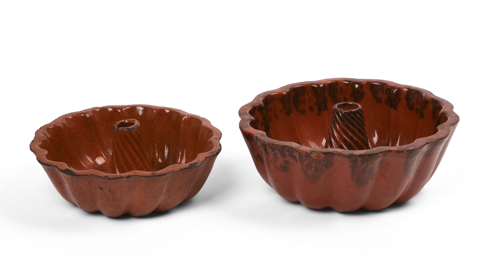 Two New England Redware Bundt Pans.: Diameters 6.75 and 8 inches. A few small chips. SHIPPING: We offer very competitively priced in house shipping for all items in this sale. Please contact us for a quote.