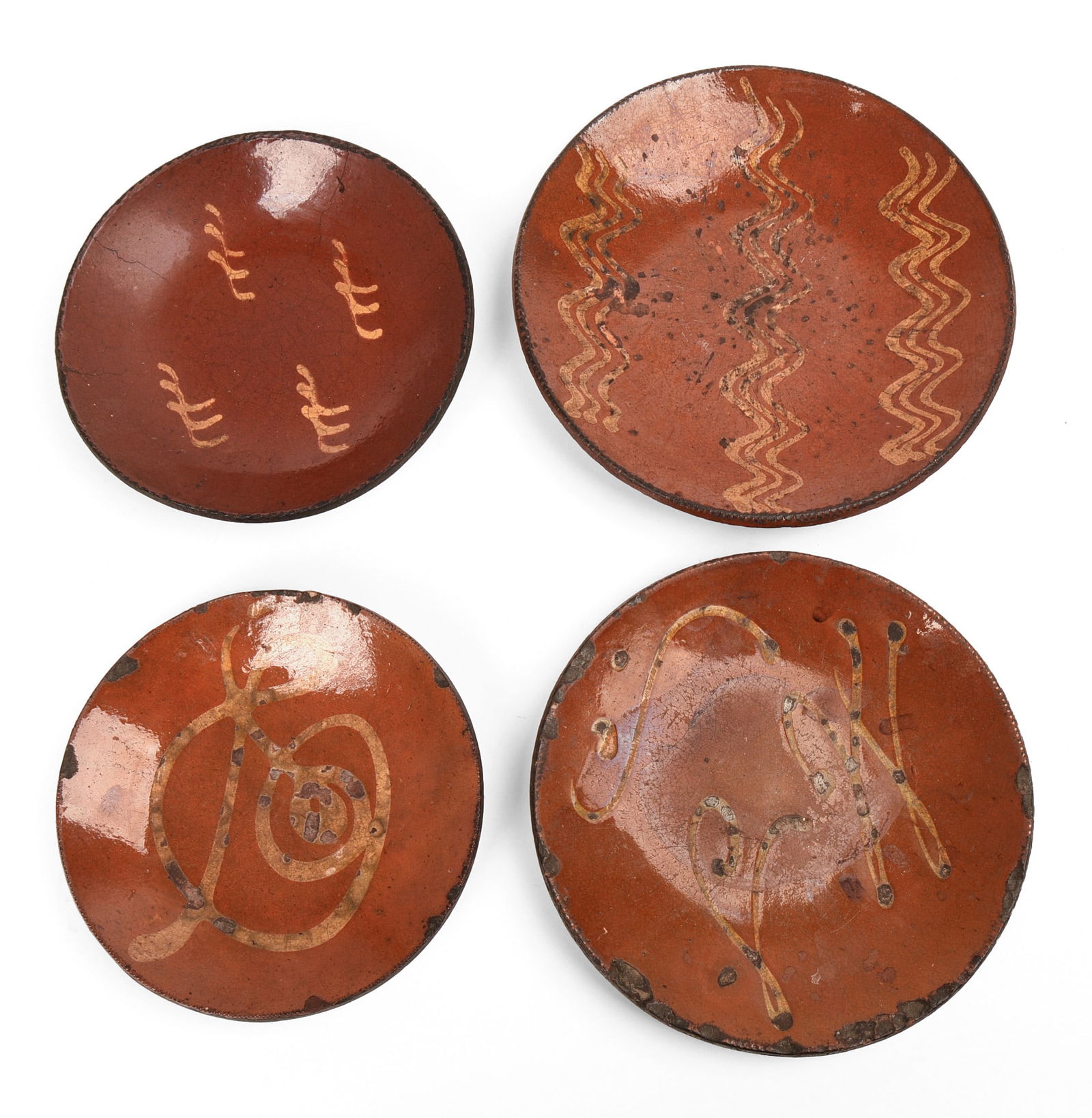Four Early American Slip Decorated Redware Plates. (1 of 4)