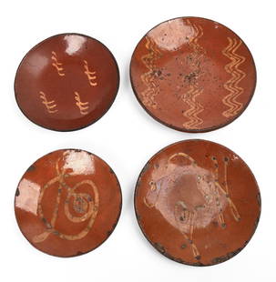 Four Early American Slip Decorated Redware Plates.: Diameters 8 to 10 inches. All with rim chips, one with hairline crack. SHIPPING: We offer very competitively priced in house shipping for all items in this sale. Please contact us for a quote.