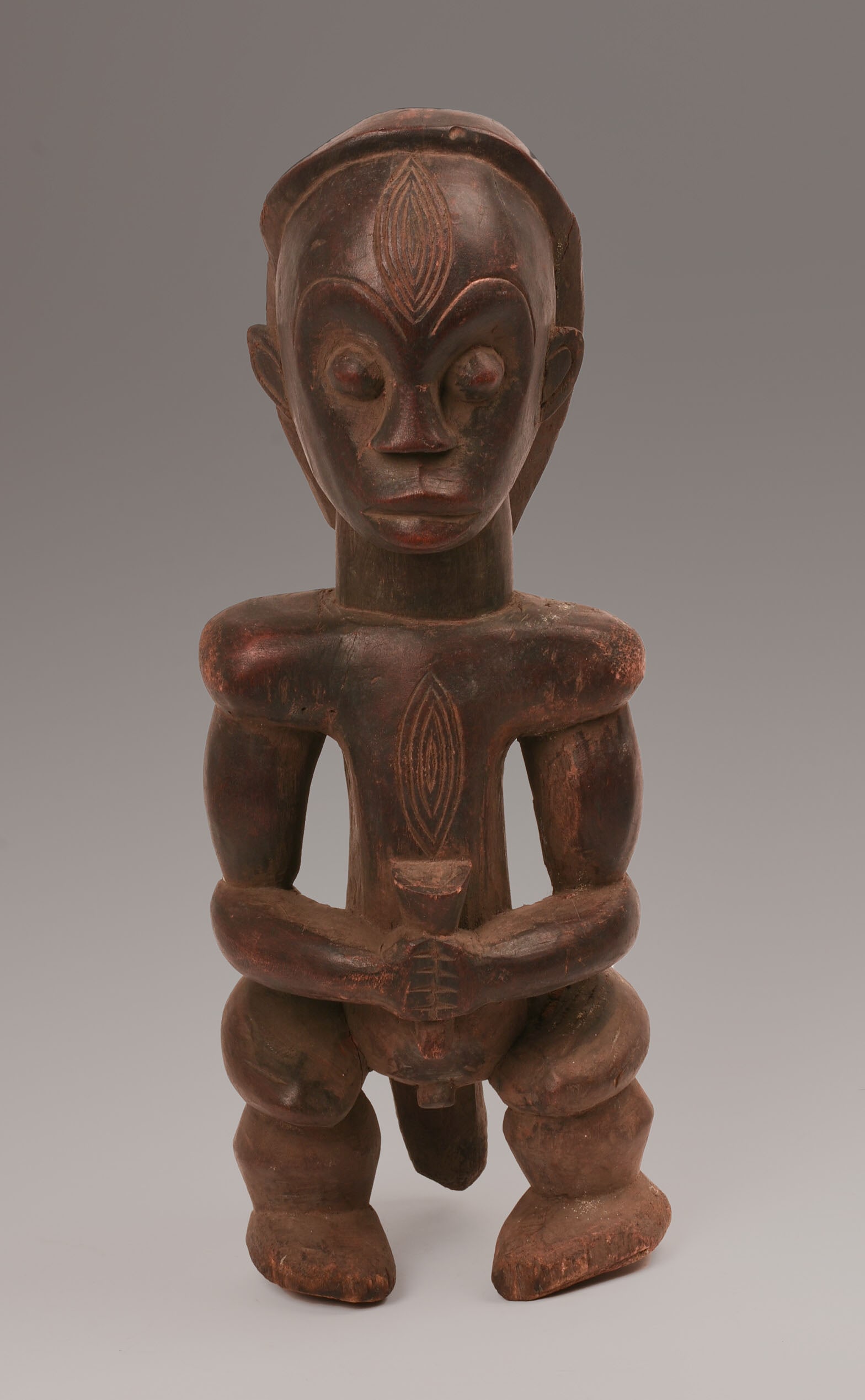 African Seated Figure Sculpture, Possibly Fang.: Height 16 inches. Good condition, some minor surface loss. SHIPPING: We offer very competitively priced in house shipping for all items in this sale. Please contact us for a quote.
