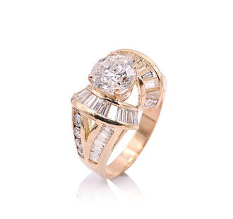 18K Yellow Gold Diamond Ring.: Round brilliant cut diamond center stone, 2.19ct. 42 baguette and round brilliant cut diamond accent stones, 2.00ct. Gross total weight 9.4 Grams. Size 6.75. IN HOUSE SHIPPING: We offer very