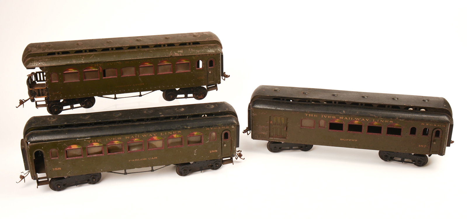 Three Ives Railway Standard Gauge Parlor Cars.: 187, 188 and 189. Fair condition, some scratches and rust. IN HOUSE SHIPPING: We offer very competitively priced in house shipping for all items in this sale. Please contact us for a quote.