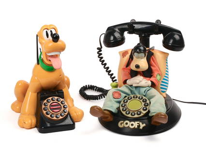 Two Disney Telephones.: One Goofy, one Pluto. Some small moving parts on each. Goofy phone height 9 1/4, width 9 inches, depth 11 inches. Phones are untested, appear in good condition with some wear light wear. IN HOUSE SHIP