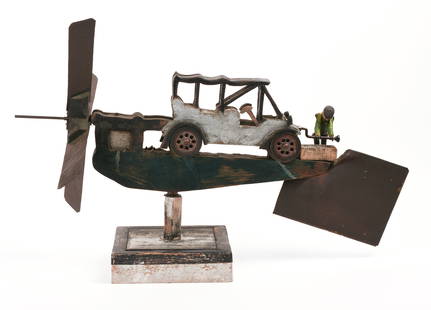 FOLK ART WHIRLIGIG OF A MAN CRANKING A CAR.: 20th century. Length 27 inches. Very good condition. IN HOUSE SHIPPING: We offer very competitively priced in house shipping for all items in this sale. Please contact us for a quote.
