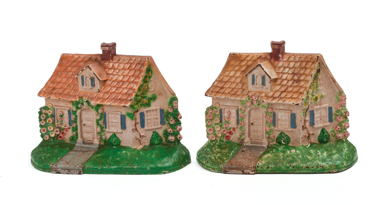 PAIR OF CAST IRON HOUSE DOORSTOPS.: Both with yellow roofs, blue shutters, and green lawns. Both stamped "211" on back. Height 5 5/8 inches, width 7.75 inches. Varying degrees of paint chipping. IN HOUSE SHIPPING: We offer very competit