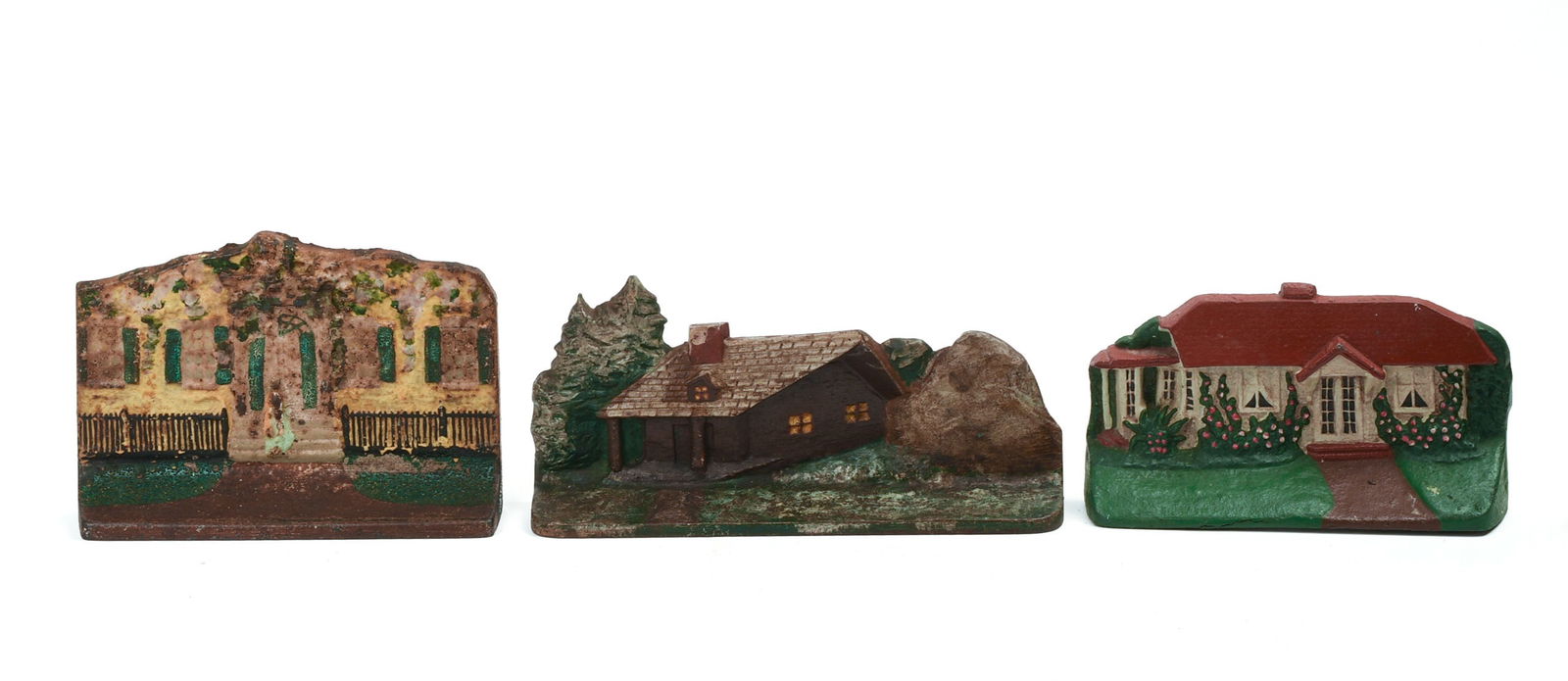 THREE CAST IRON HOUSE DOORSTOPS.: Height of tallest 5.5 inches, width 8 1/8 inches. Two with varying paint chipping, one with some paint cracking. IN HOUSE SHIPPING: We offer very competitively priced in house shipping for all items i