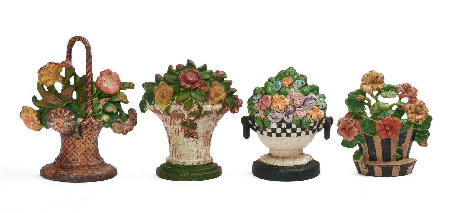 FOUR CAST IRON FLOWER BOUQUET DOORSTOPS.: Height of tallest 9 5/8 inches, width 8 inches. Varying degrees of paint chipping. IN HOUSE SHIPPING: We offer very competitively priced in house shipping for all items in this sale. Please contact us