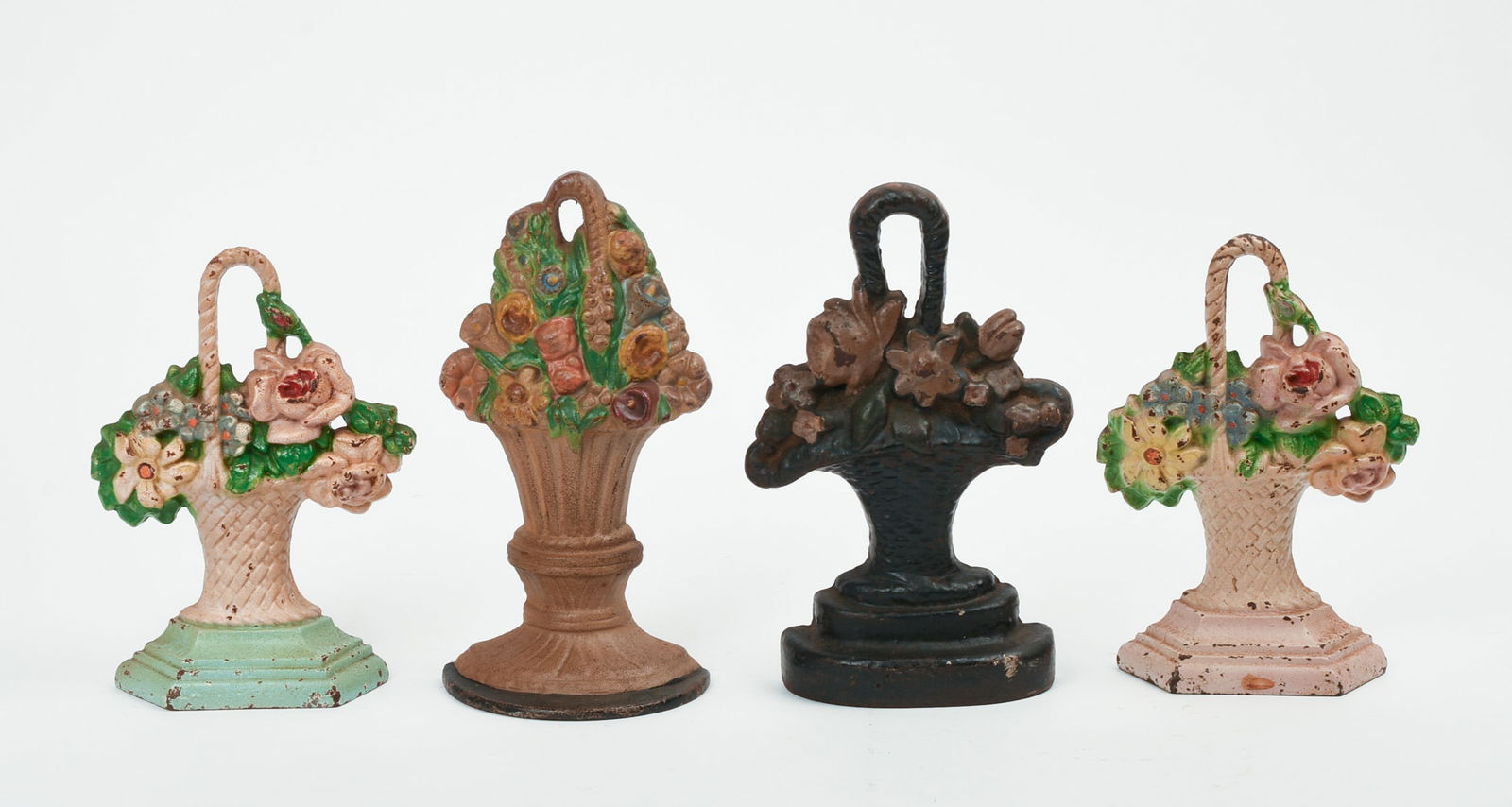 FOUR SMALL CAST IRON FLOWER BOUQUET DOORSTOPS.: Height of tallest 8 1/8 inches, width 4.25 inches. All with some paint chipping or loss. IN HOUSE SHIPPING: We offer very competitively priced in house shipping for all items in this sale. Please cont