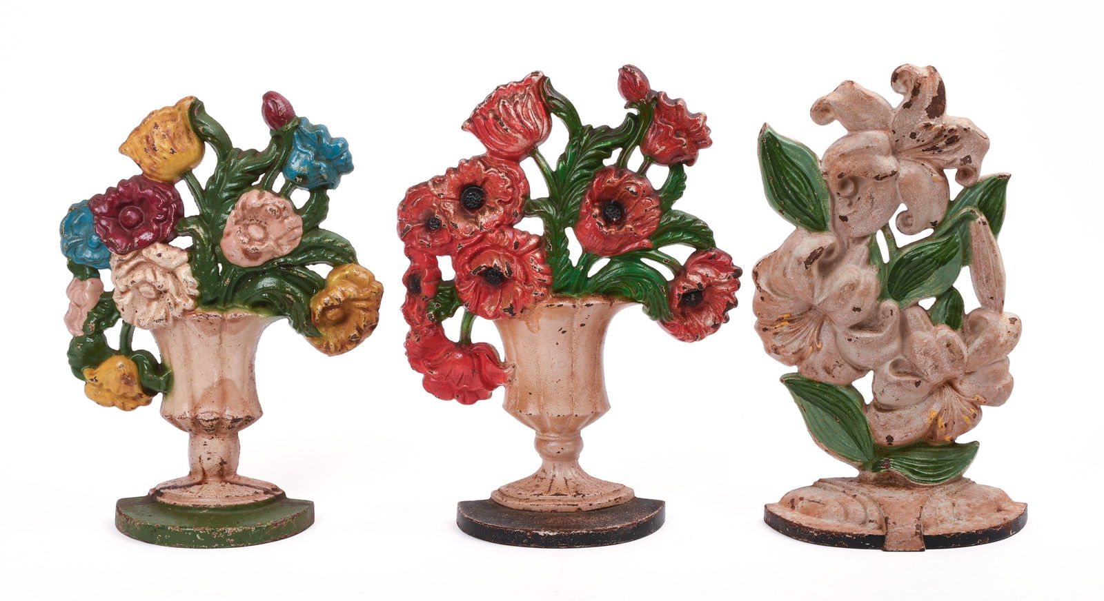 THREE CAST IRON FLOWER BOUQUET DOORSTOPS.: Height of tallest 10.5 inches, width 6 inches. Varying degrees of paint chipping. IN HOUSE SHIPPING: We offer very competitively priced in house shipping for all items in this sale. Please contact us