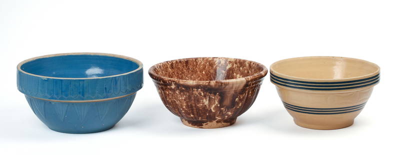 THREE STONEWARE BOWLS.: One yellow ware, diameter 9.25 inches, a Bennington example, diameter 10.5 inches, and a blue bowl, diameter 10.5 inches. Good condition, yellow ware bowl has a couple very minor rim chips. IN HOUSE S