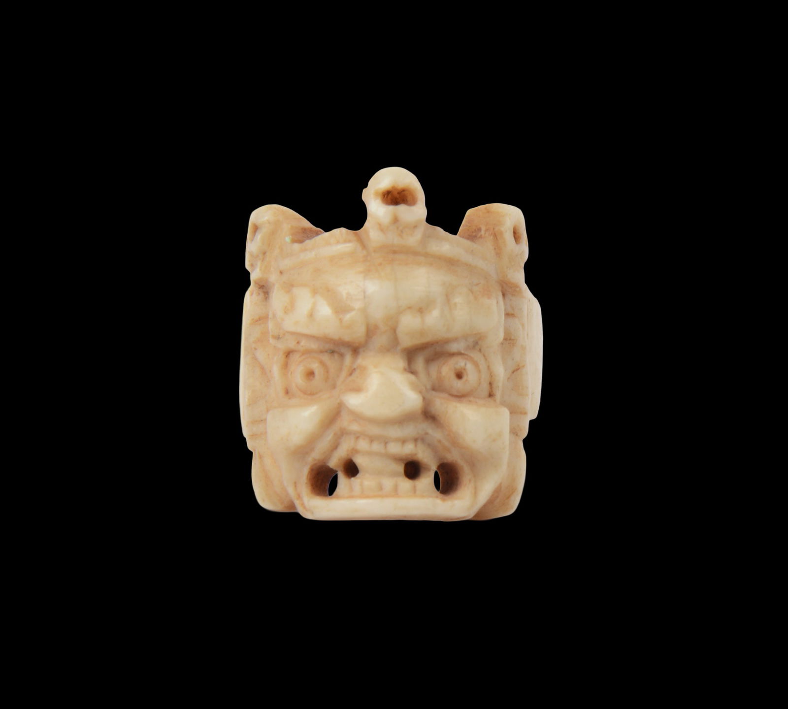 TIBETAN CARVED BONE MASK AND SKULLS RING: Early 20th century. Size 6.5.
