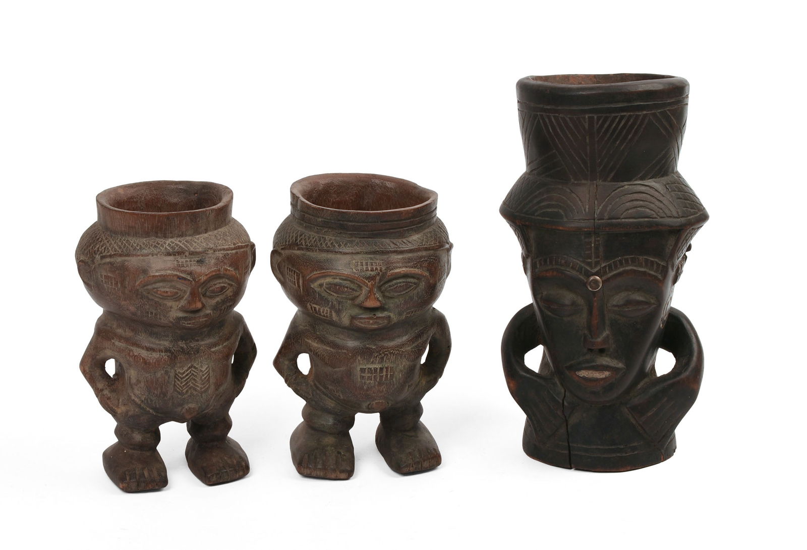 THREE AFRICAN CARVED CUPS.: Heights 6.5 and 9 inches.