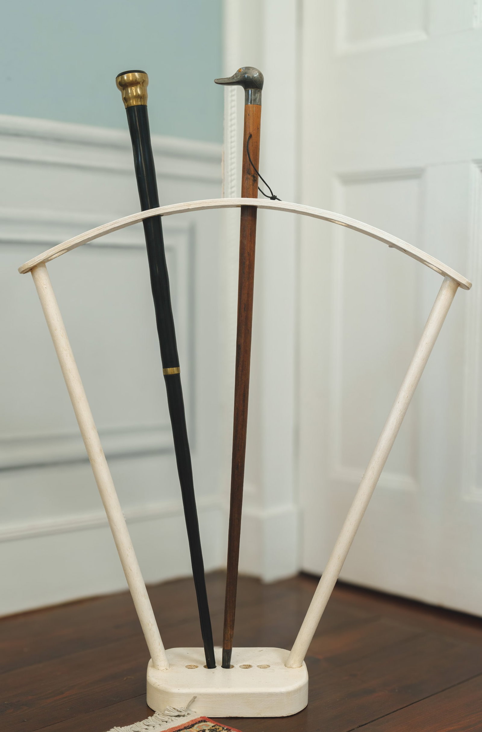 Two Canes.: One with duck handle, length 33 inches. The other with brass whale inlay, length 33 inches. Together with a custom cane stand.