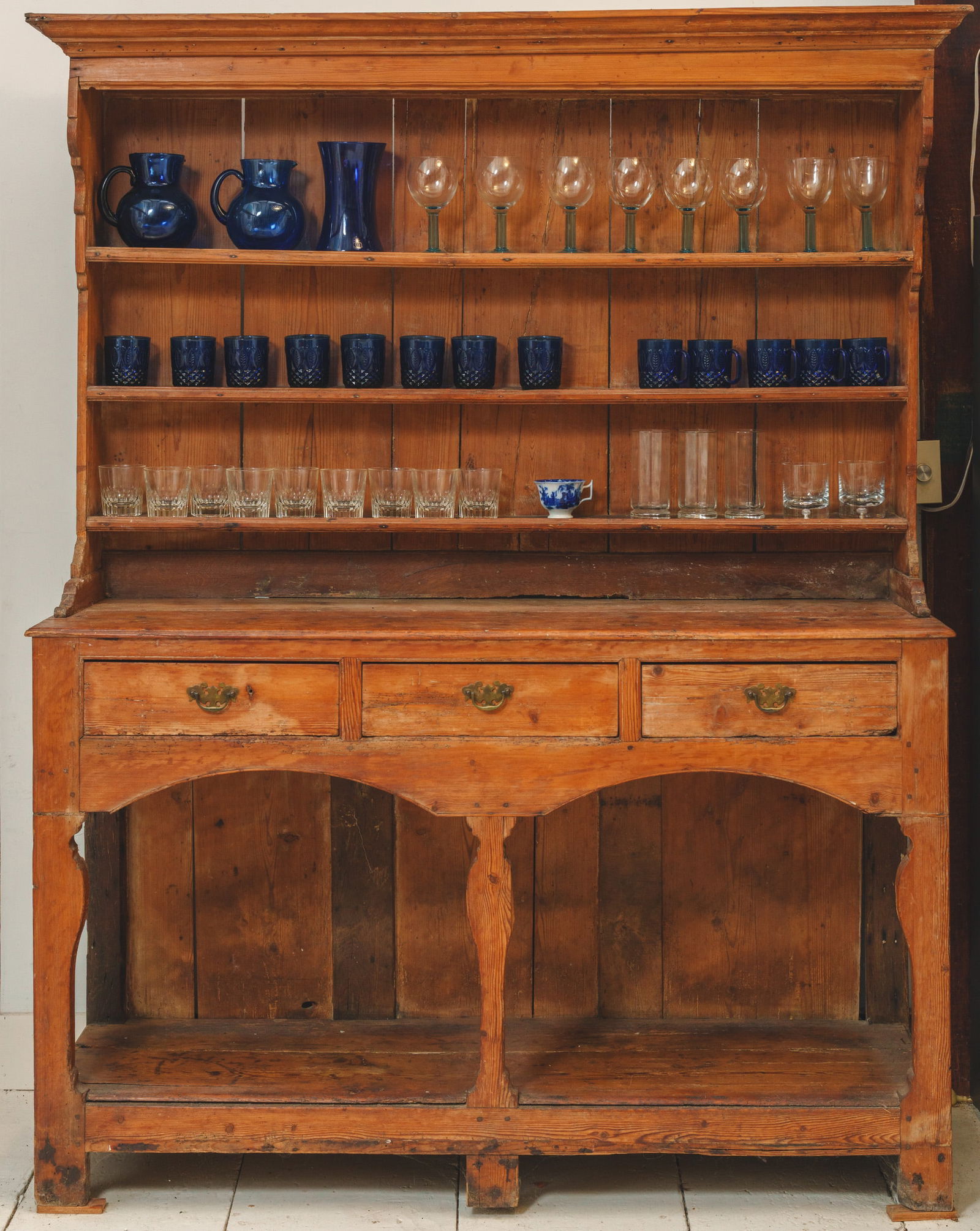 Collection of Glasses and Pitchers.: Including a pair of cobalt blue pitchers, heights 7 inches, and numerous cobalt blue mugs, rocks glasses, stem glasses, and others.