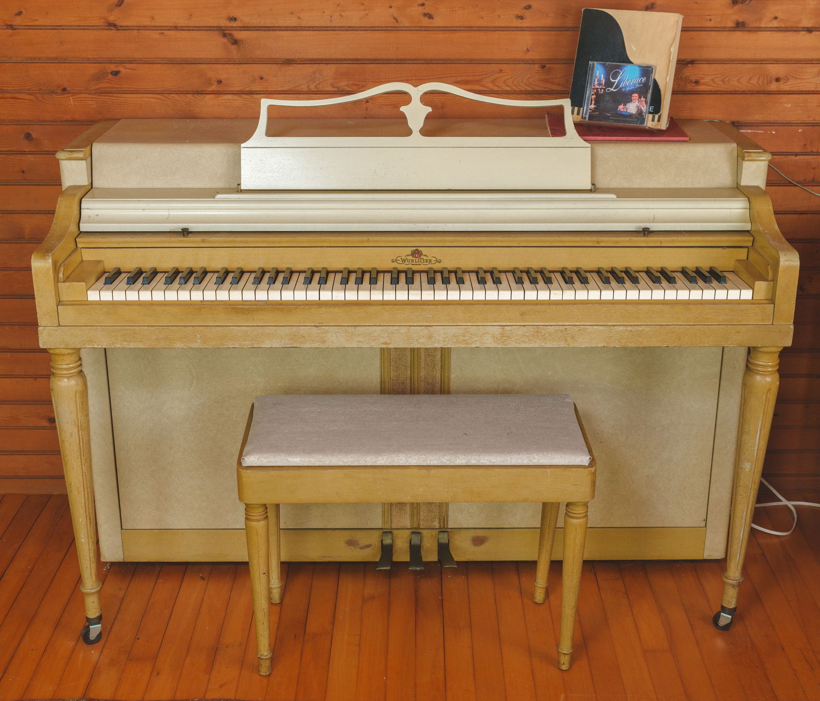 Wurlitzer Spinet and Bench in Yellow Paint.: Height 38 inches, length 55 inches, depth 25 inches. According to tradition, this piano was played by Liberace at a party held by James Hunt Barker. Includes Liberace CD and notepad.