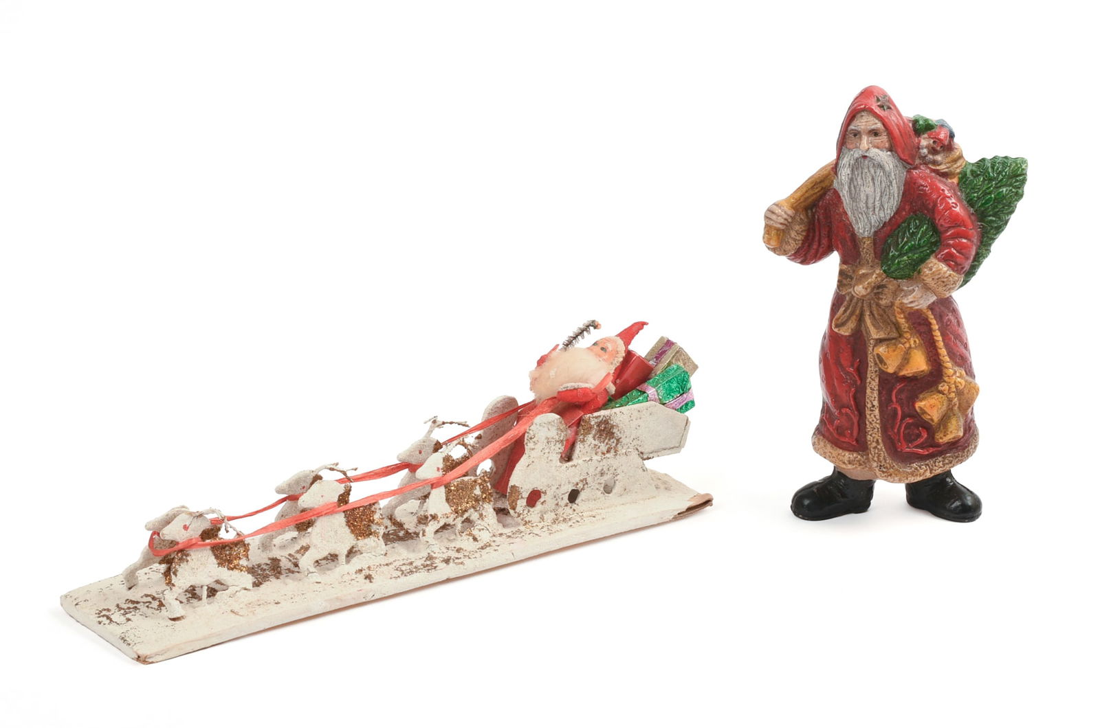 Two Vintage Santa Decorations.: Sleigh, length 10.5 inches, and celluloid figure, height 6.5 inches.