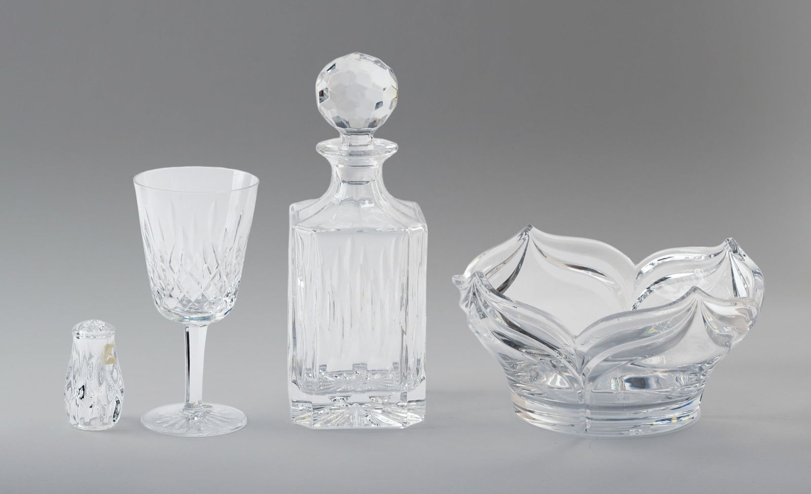 Four Crystal Pieces.: A bowl, diameter 9 inches, Waterford goblet, height 7 inches, decanter and a salt shaker. Salt shaker missing bottom plug.