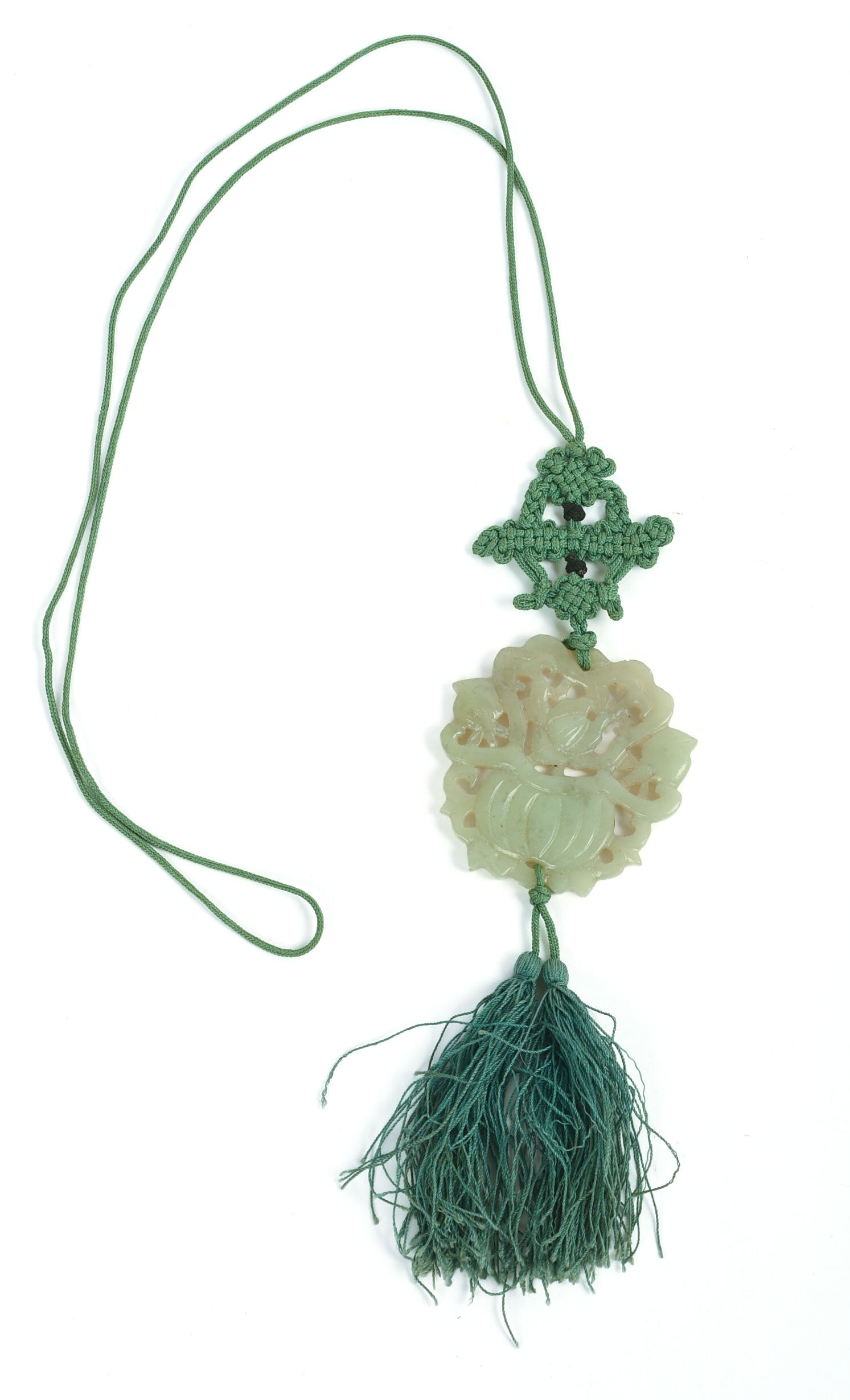 CHINESE CARVED JADE PENDANT.: On silk cord. Early 20th century. 2.25 x 2 inches.