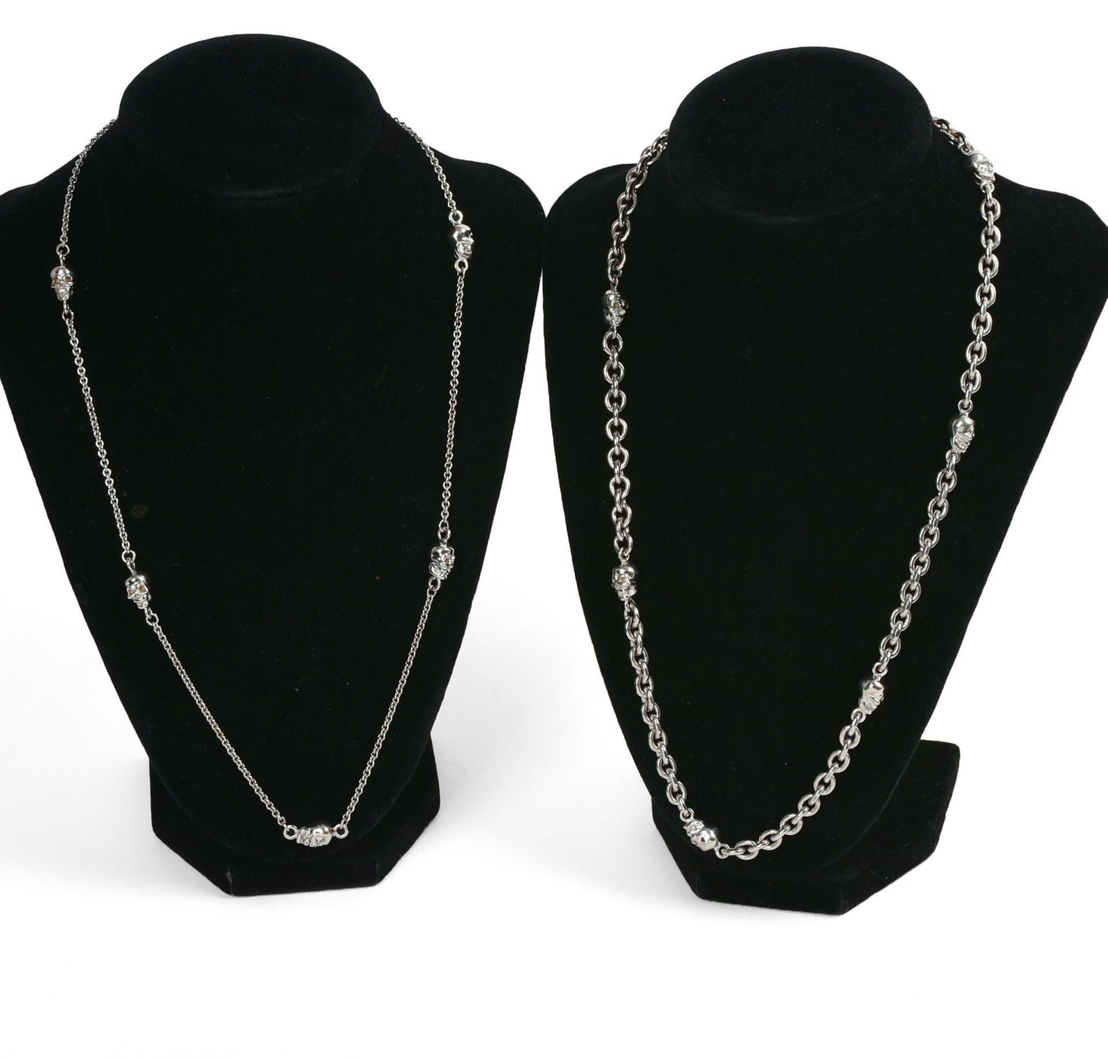 TWO ROBIN ROTENIER STERLING SILVER SKULL NECKLACES.: Lengths 20 inches, 74 and 26 grams.