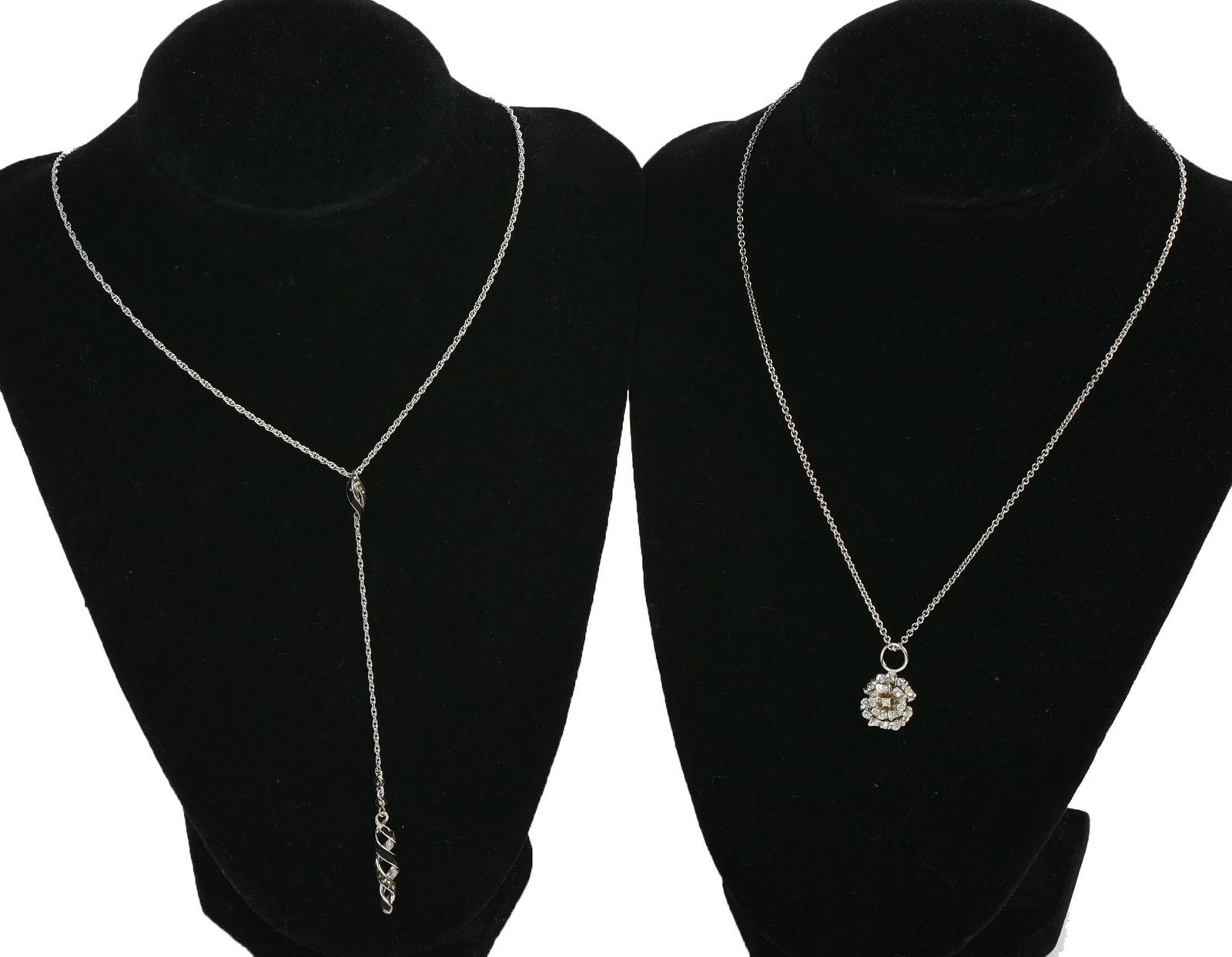 Two Jan Leslie Sterling Silver Pendant Necklaces.: One with onyx and diamonds, length 24 inches. The other with flower, length 16 inches. 11 grams.