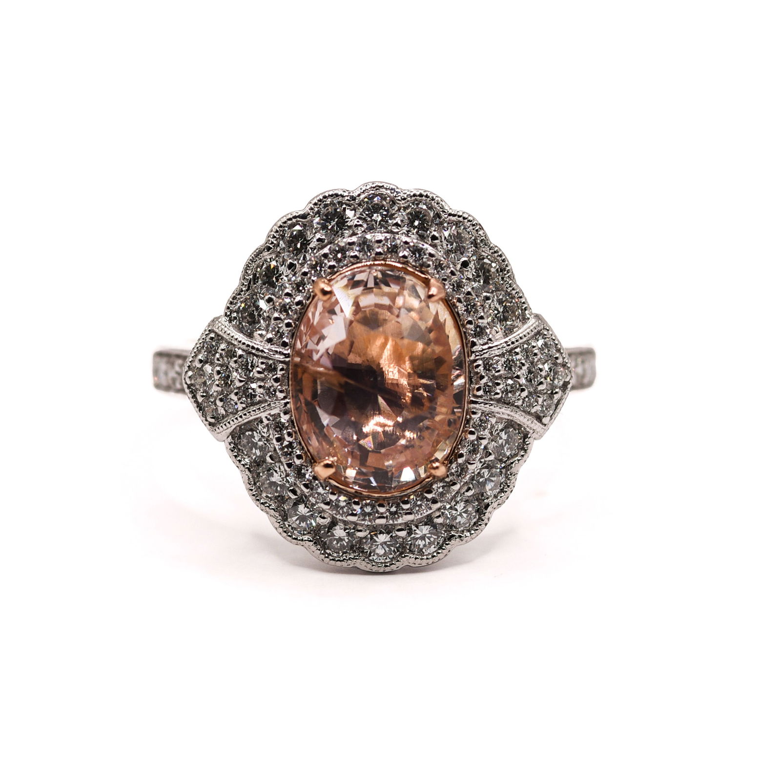 PLATINUM AND 18K YELLOW GOLD NATURAL UNHEATED LIGHT PINK SAPPHIRE CORUNDUM AND DIAMOND RING: Oval brilliant, faceted cut, light pink sapphire corundum centerstone, 3.60 CT. Round brilliant cut diamond accent stones, 0.76 CT, 70 pieces. Gross total weight 7.3 Grams. Size 6.75.