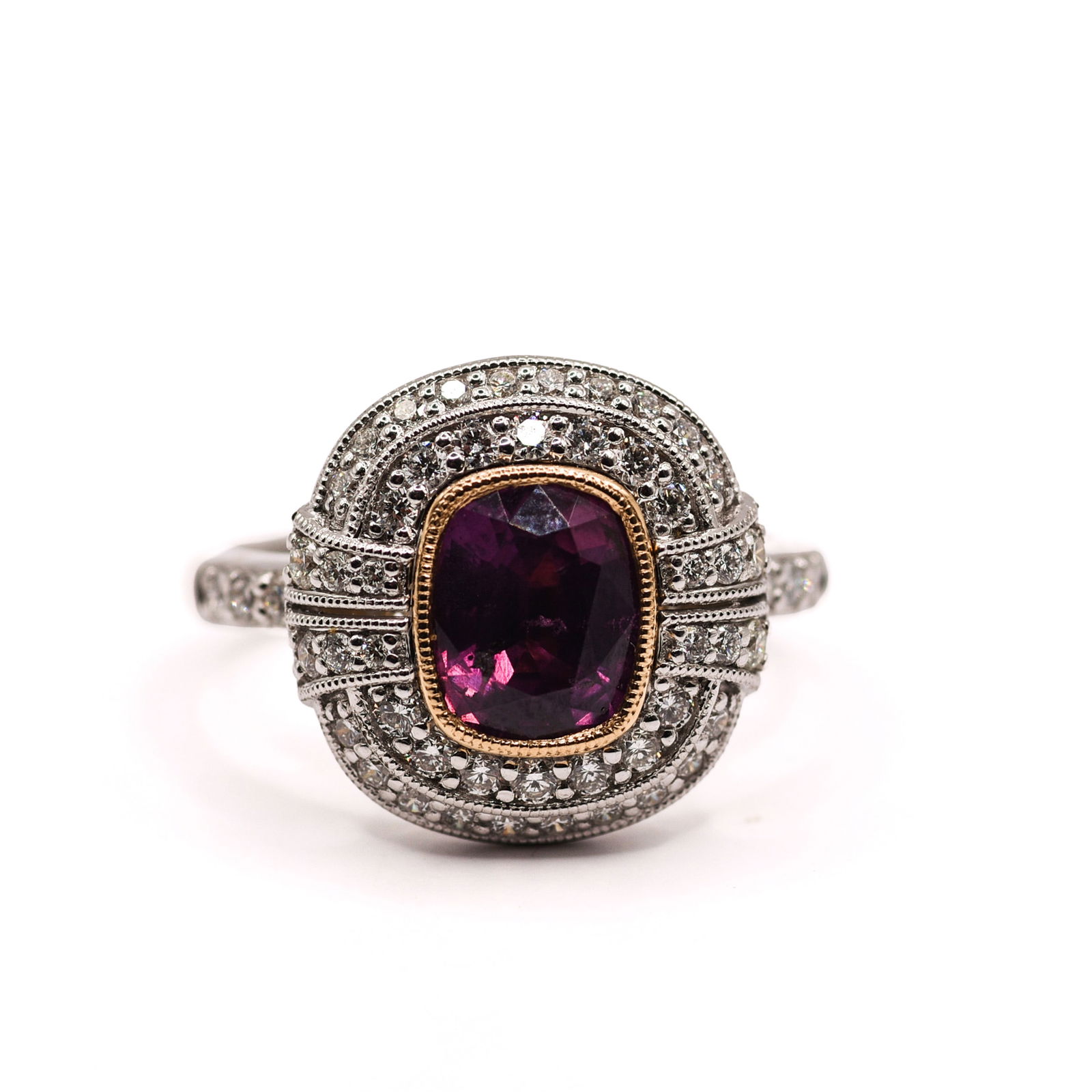 PLATINUM AND 18K YELLOW GOLD KASHMIR AND DIAMOND RING: Cushion brilliant cut crown, modified step cut pavilion, purplish-pink natural Kashmir sapphire corundum center stone, 2.04 CT. Round brilliant cut diamond accent stones, 0.64CT, 52 pieces. Gross tota