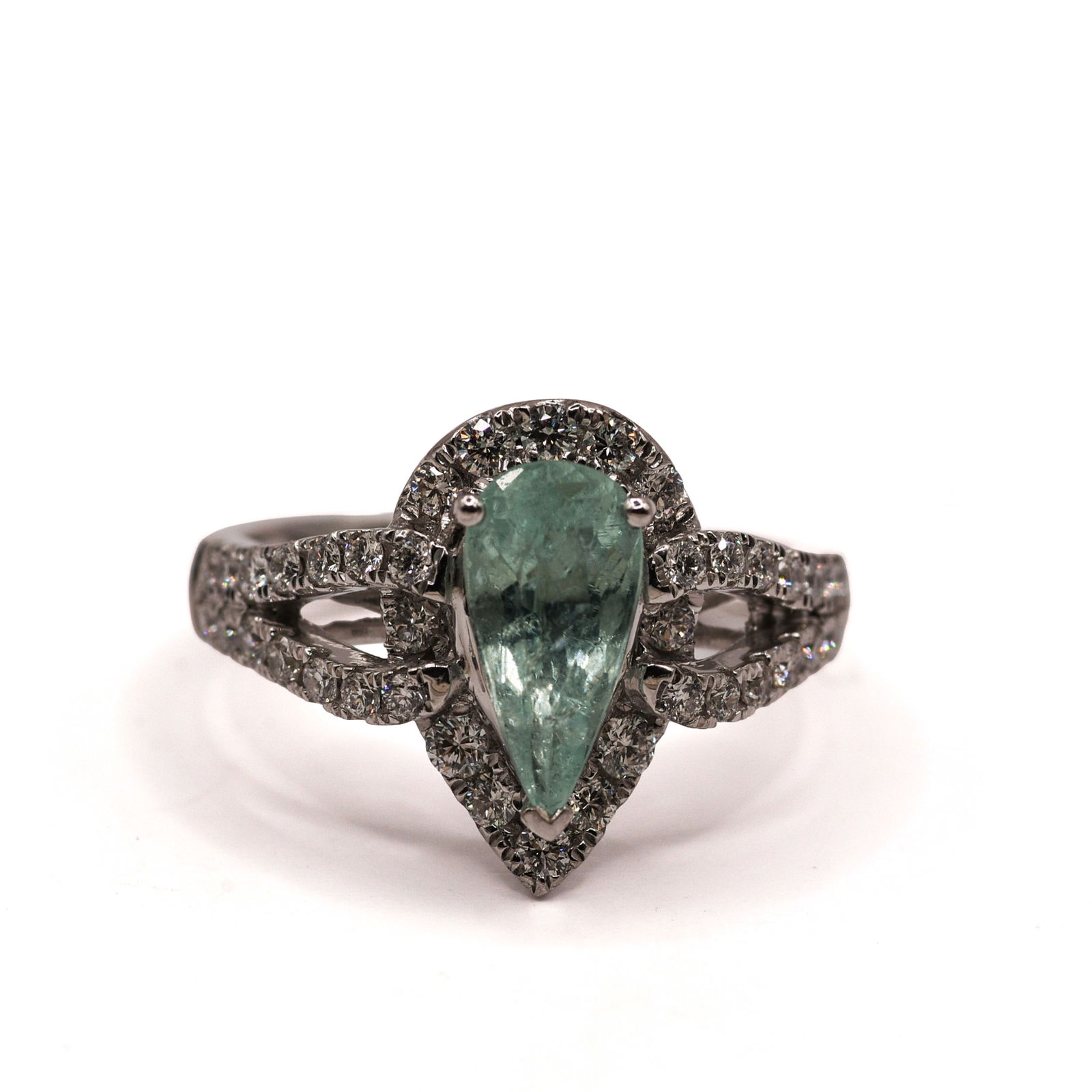PLATINUM NATURAL MOZAMBIQUE PARAIBA TOURMALINE AND DIAMOND RING: Pear modified brilliant, faceted cut natural Mozambique Paraiba tourmaline, green-blue, centerstone, 1.44 CT. Round brilliant cut diamond accent stones, 0.75CT, 40 pieces. Gross total weight 7.4