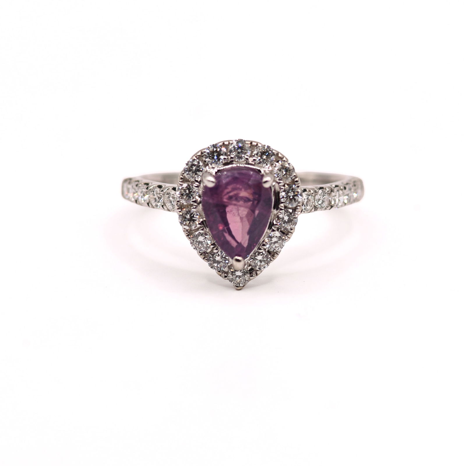 18K WHITE GOLD KASHMIR SAPPHIRE AND DIAMOND RING: Pear, brilliant cut crown, step pavilion cut, purple-pink unheated Kashmir sapphire, 1.60 CT. Round brilliant cut diamond accent stones, 0.54 Ct, 24 pieces. Gross total weight 3.6 Grams. Size 6.25.