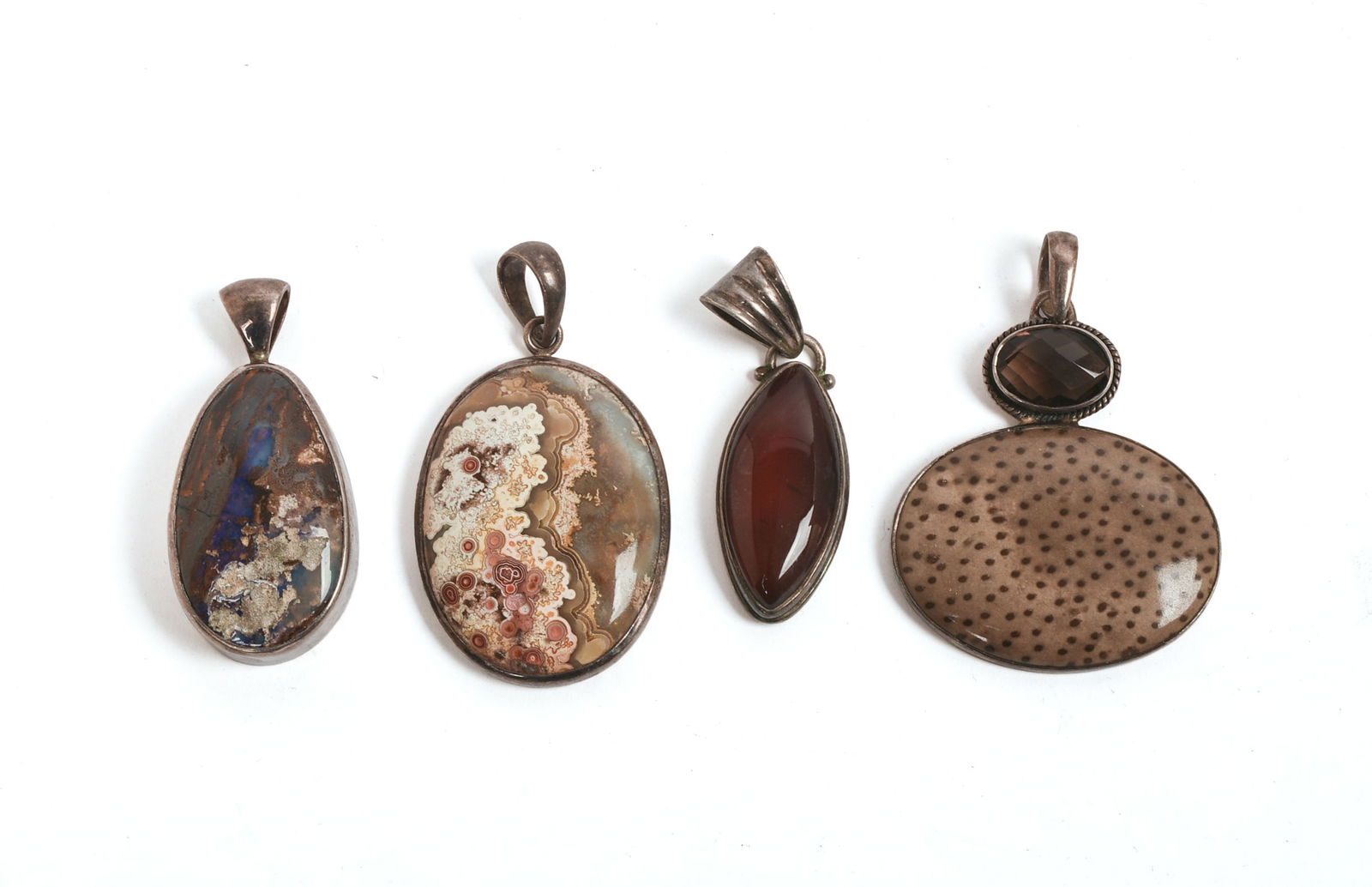 Four Contemporary Sterling Pendants.: All approximately 1.5 inches long.
