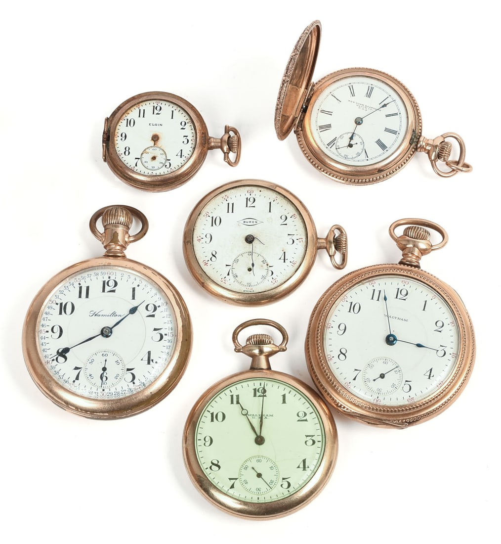 Six Gold Filled Pocket Watches: 2 Waltham, 1 Hamilton, 1 New York Standard Watch Co., 1 Elgin, 1 Buren, latter 2 missing crystals. Diameters 1.375 to 2.25 inches. Not tested for operation.